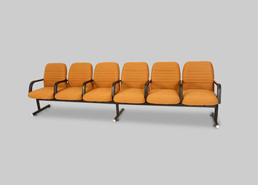Row of 6 orange school auditorium chairs