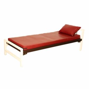 A red-colored single bed cot with mattresses and a pillow.