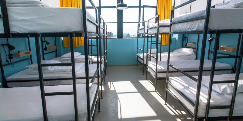 Inside view of the hostel bedroom with clean bunker beds for students.