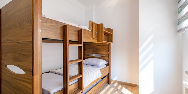 A picture of a hostel bunk bed showcasing creative space-saving ideas.