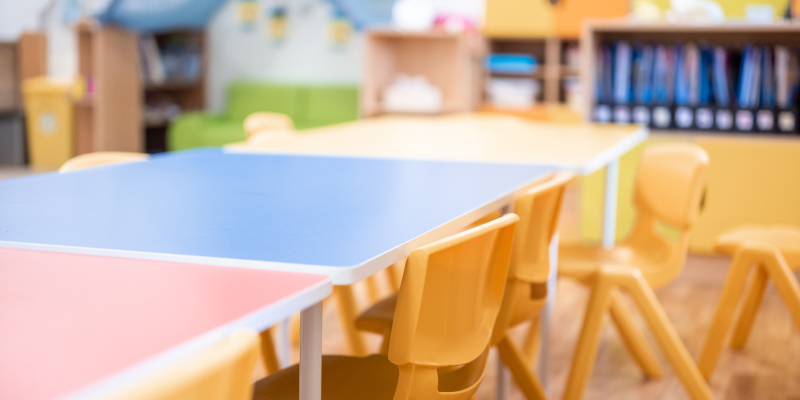 Colorful kindergarten class with chairs and desks.